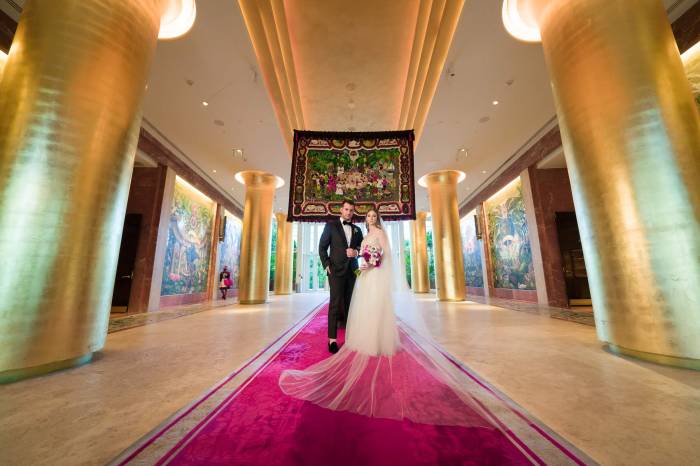 bride and groom stand in Faena entrance