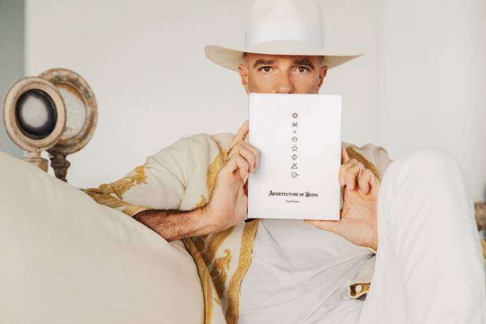 Alan Faena holding book Architecture of Being