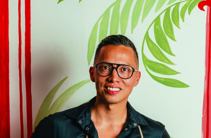 Chef Antonio leaning on a wall with a hand on his hip