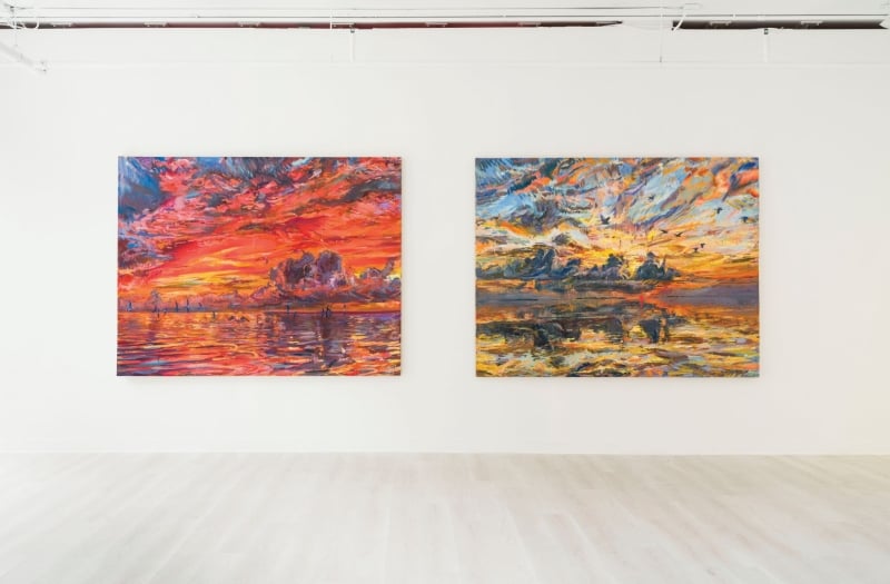 two paintings hanging in a gallery