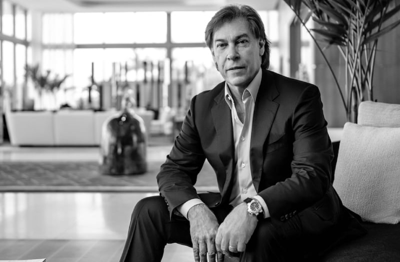 A man in a suit sitting on a chair