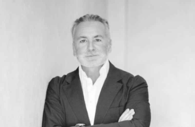 Mr. Shahab S. Karmely of KAR Properties leaning on a wall with his arms crossed