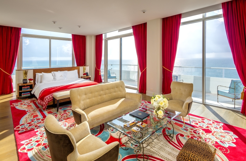 hotel bedroom with sitting area containing couch and two chairs