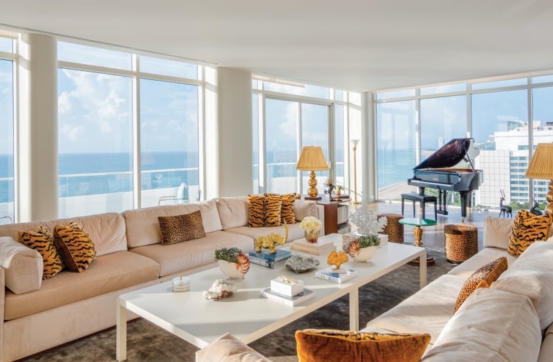 large hotel penthouse with living space and grand piano in the distance