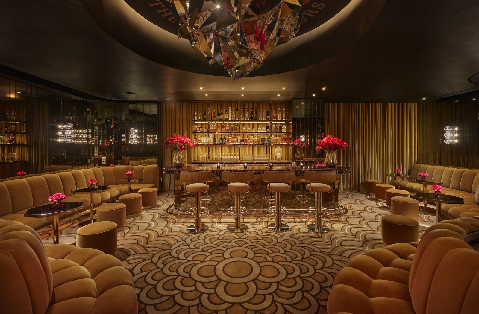 A bar with ample booth seating and gold adornments
