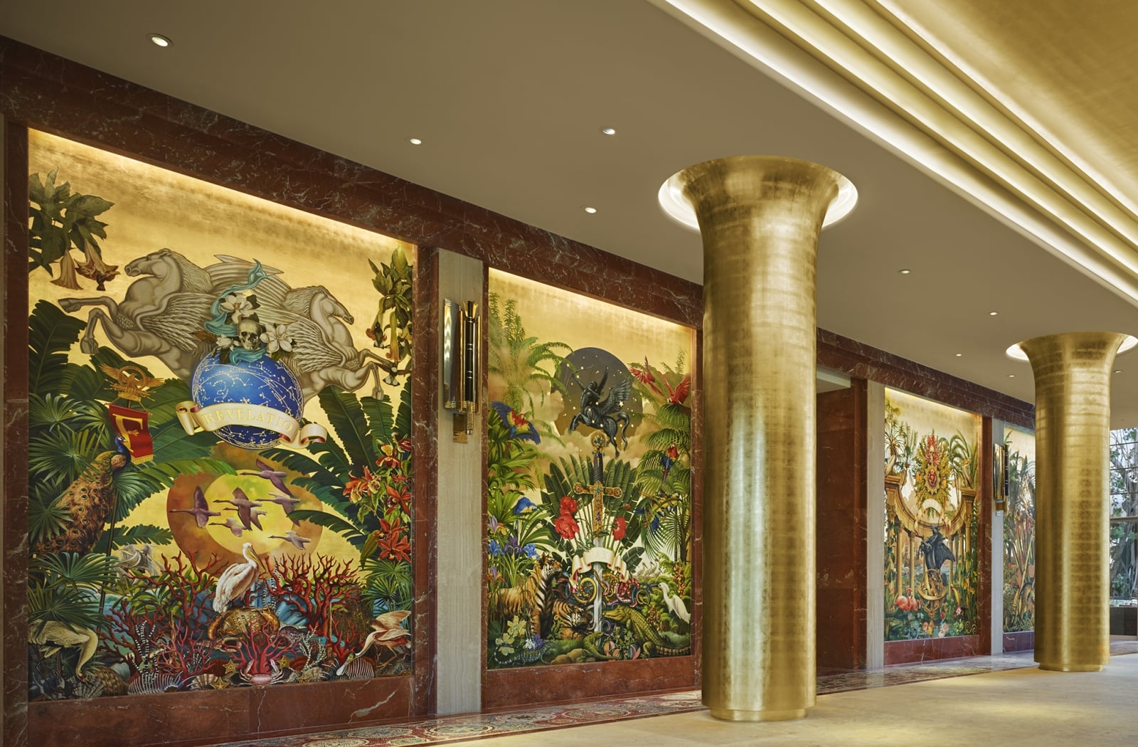 Colorful tropical murals and gold architectural columns in an elegant Faena interior