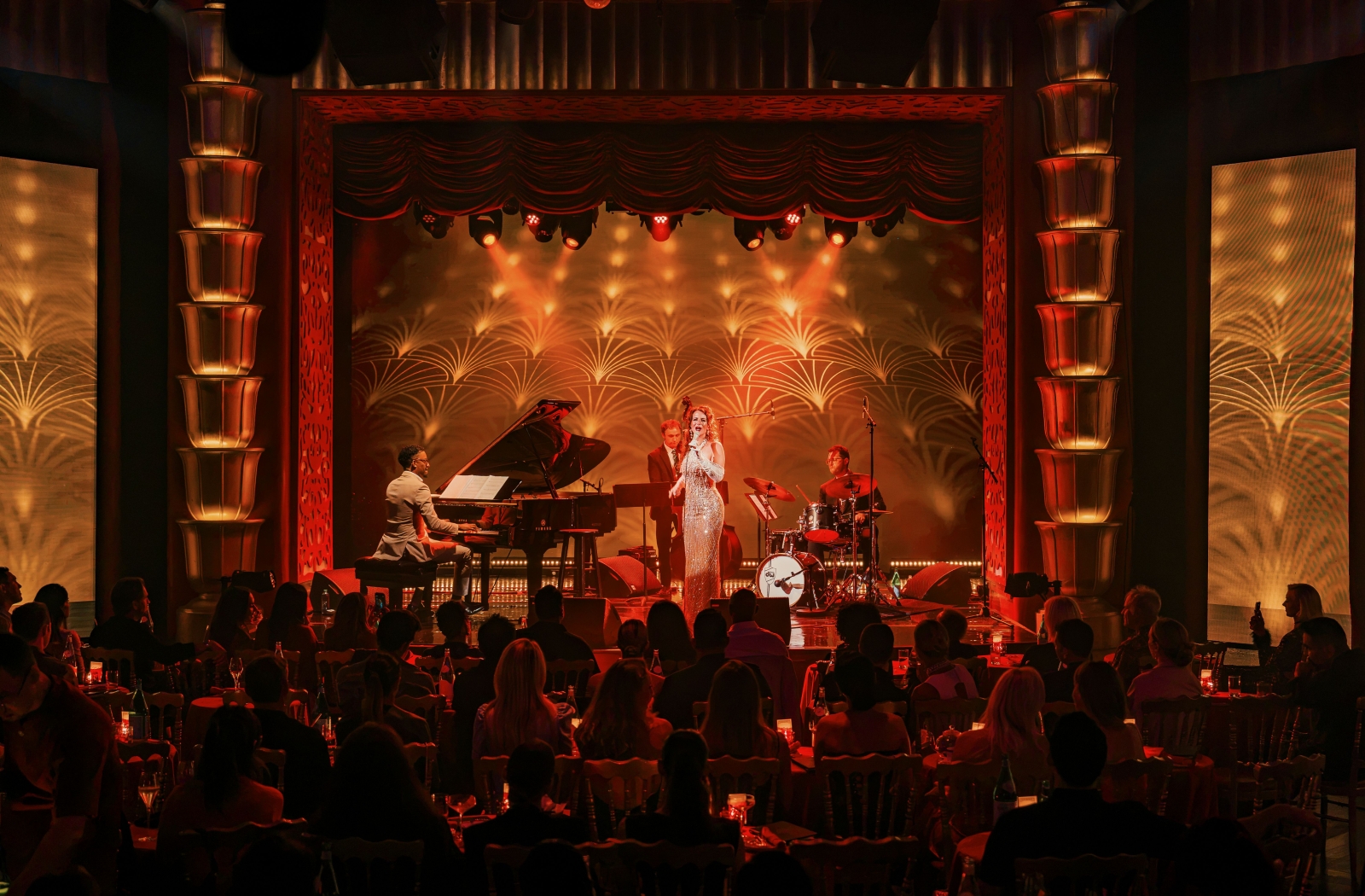 Live jazz performance with a singer, pianist, and drummer at Faena Theater