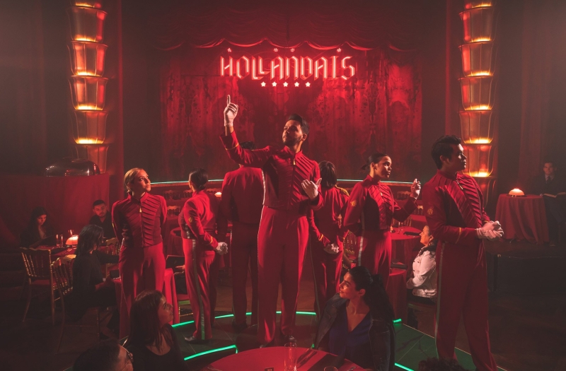 faena theater performers stand in front of stage all wearing red