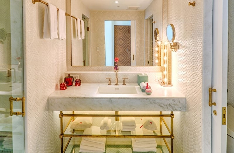 hotel bathroom with large mirror and sink