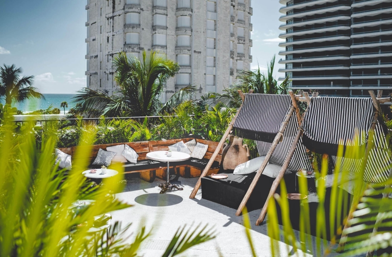 rooftop seating area with greenery framing space