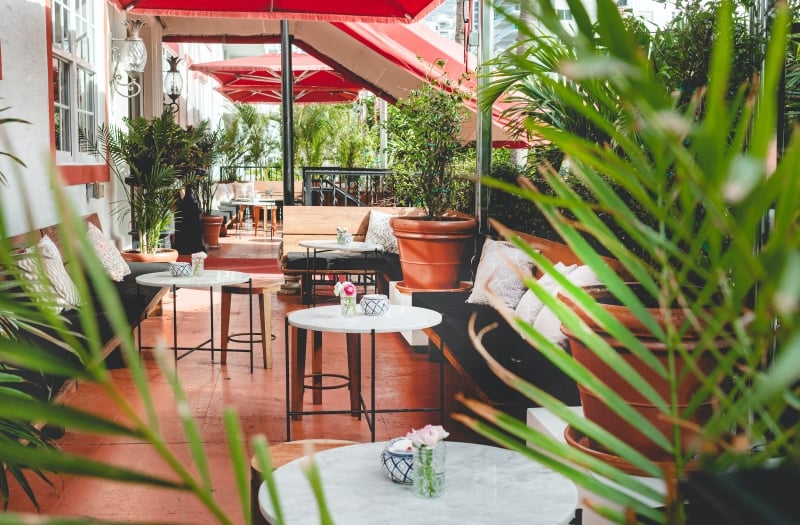 tables and greenery on patio seating area