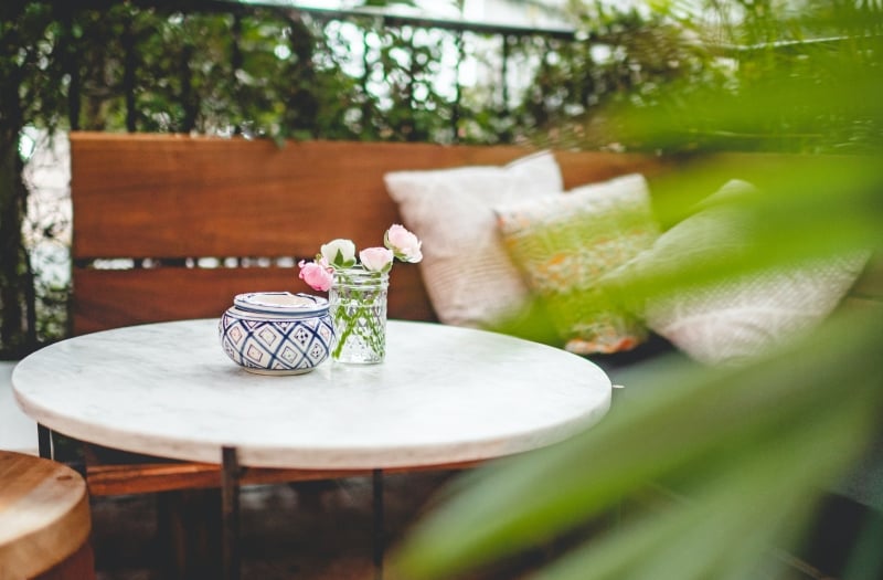 private seating area on patio surrounded by greenery