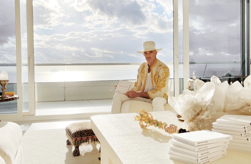 Alan Faena sitting by a balcony over the ocean