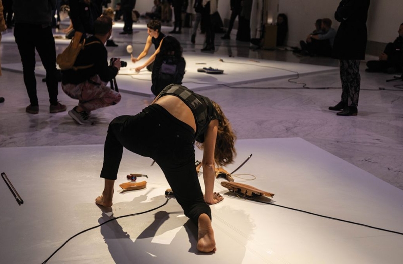 woman dressed in black performs on ground