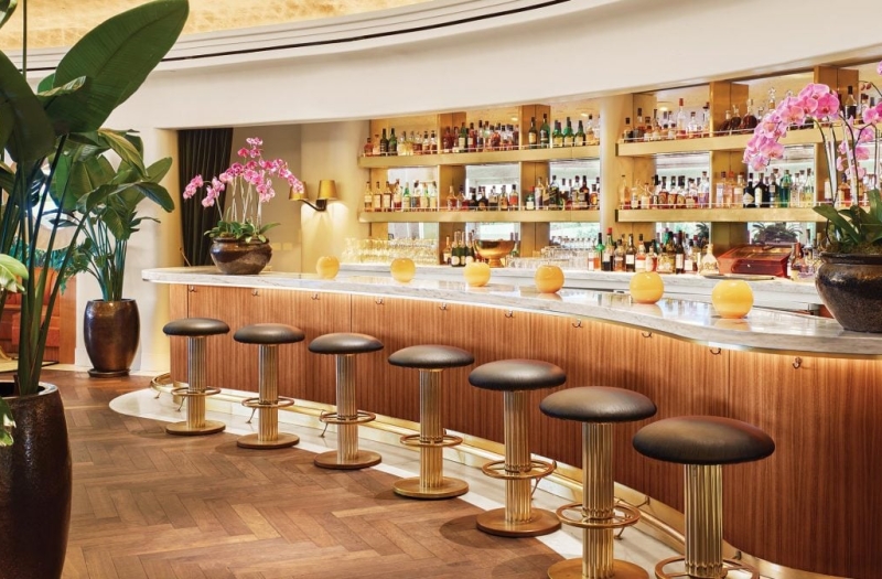 Fancy bar lined with stools