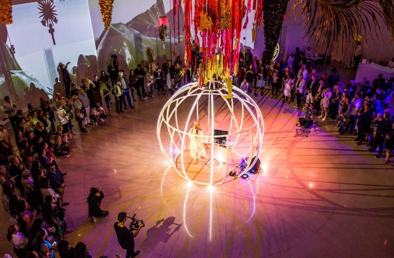 birds eye view of white sphere stage surrounded by group of people
