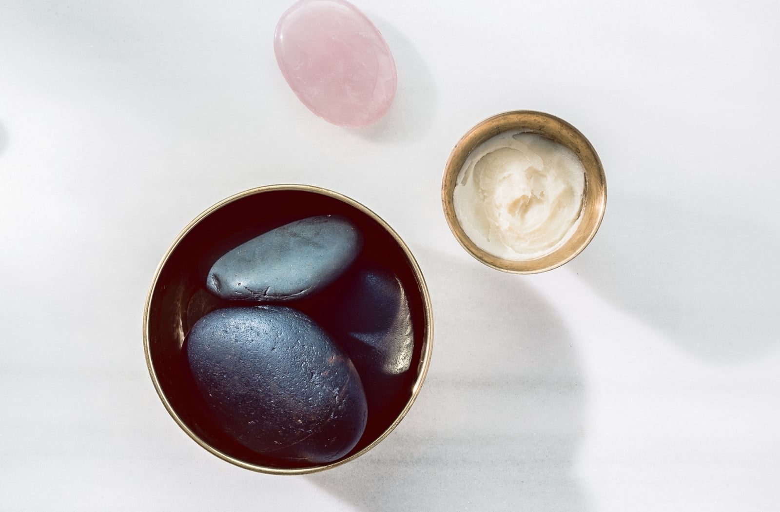 a bowl of stones and a small bowl of cream