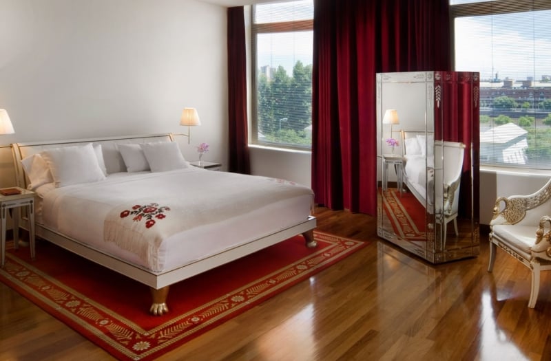 bed in hotel room with large windows