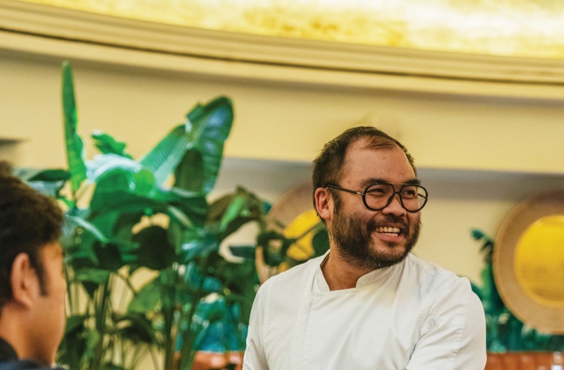 Paul Qui serving guests with a smile