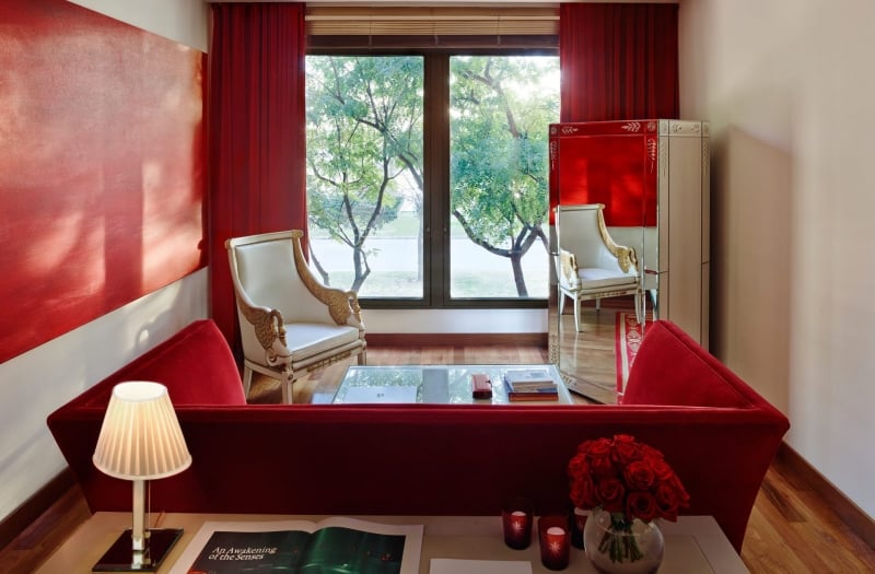 living room with red sofa and large mirror