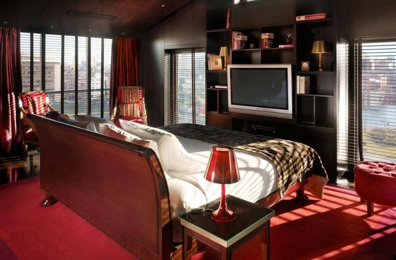 bedroom in the middle of a room facing a television
