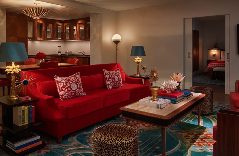 red couch seating area of hotel suite