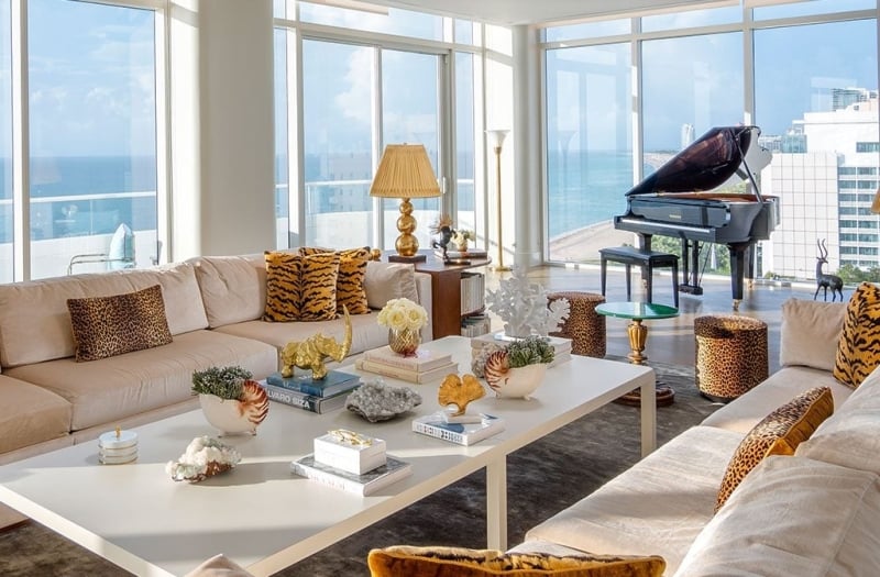 large hotel penthouse with living space and grand piano in the distance