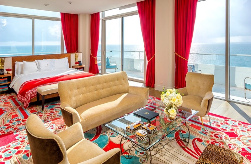 hotel bedroom with sitting area containing couch and two chairs