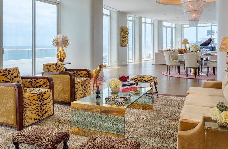 large hotel penthouse with living space and grand piano in the distance