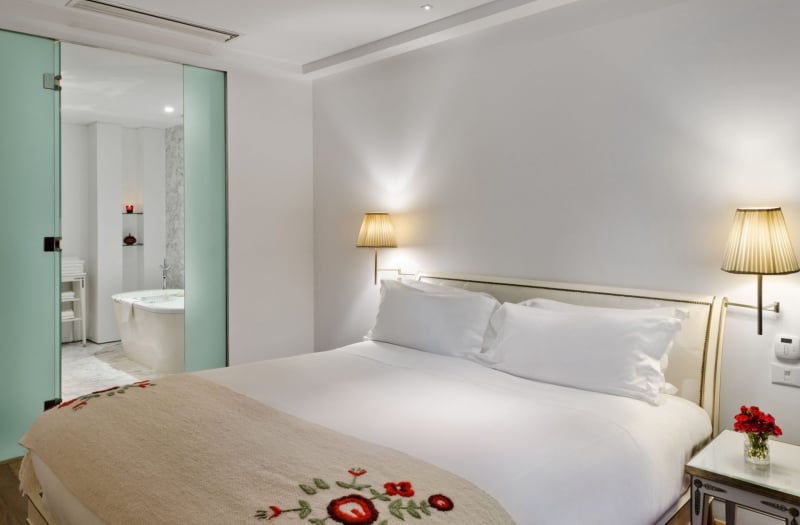 hotel bedroom with bed and door open into the bathroom