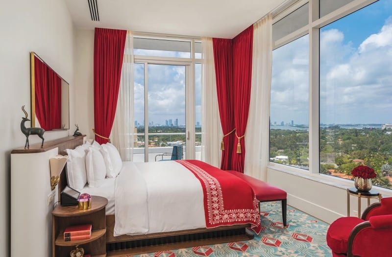 bedroom in hotel with large windows on two sides