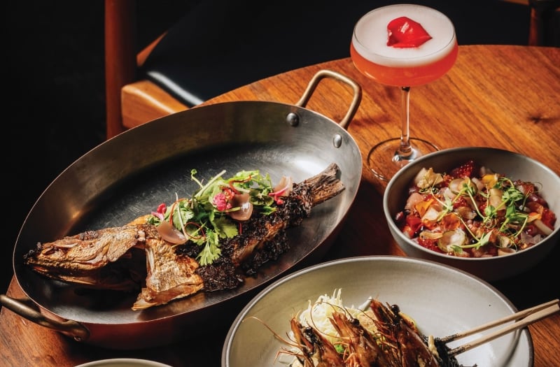 long wooden plate with food on a table