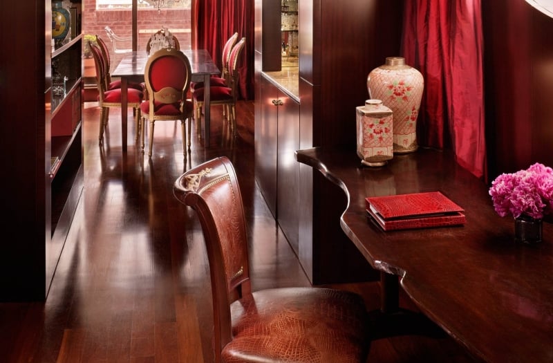 wooden desk and chair with dining table in the background