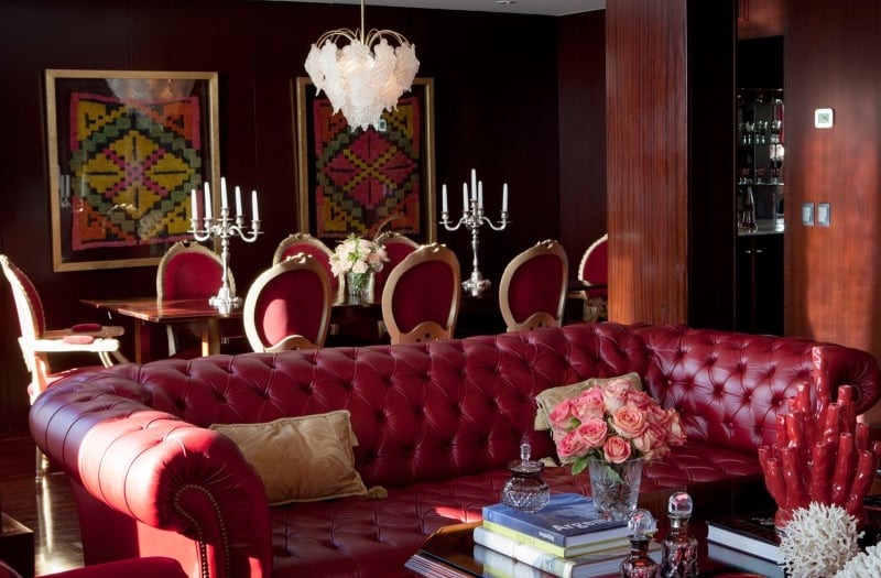 leather couch with dining table behind in hotel presidential suite