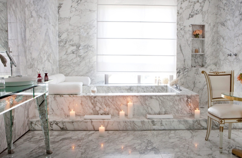 bathtub in hotel room lit by candles