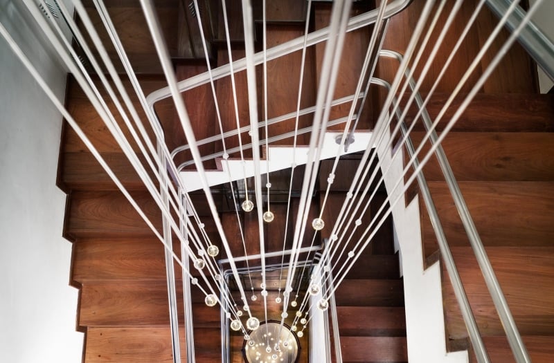 looking down a staircase with hanging lightbulbs