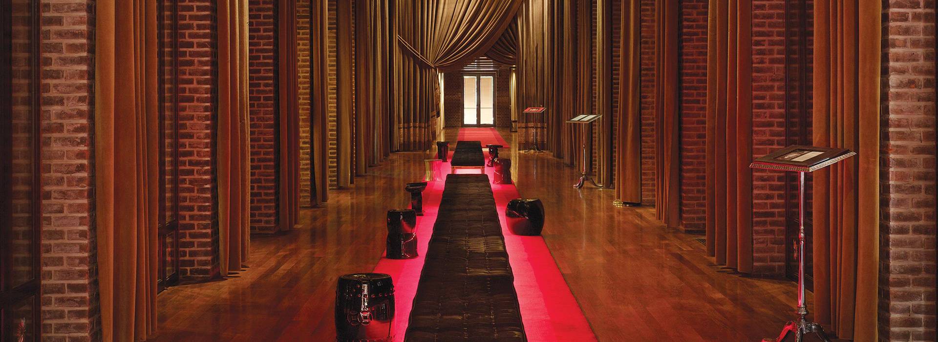 long lobby hallway with golden columns