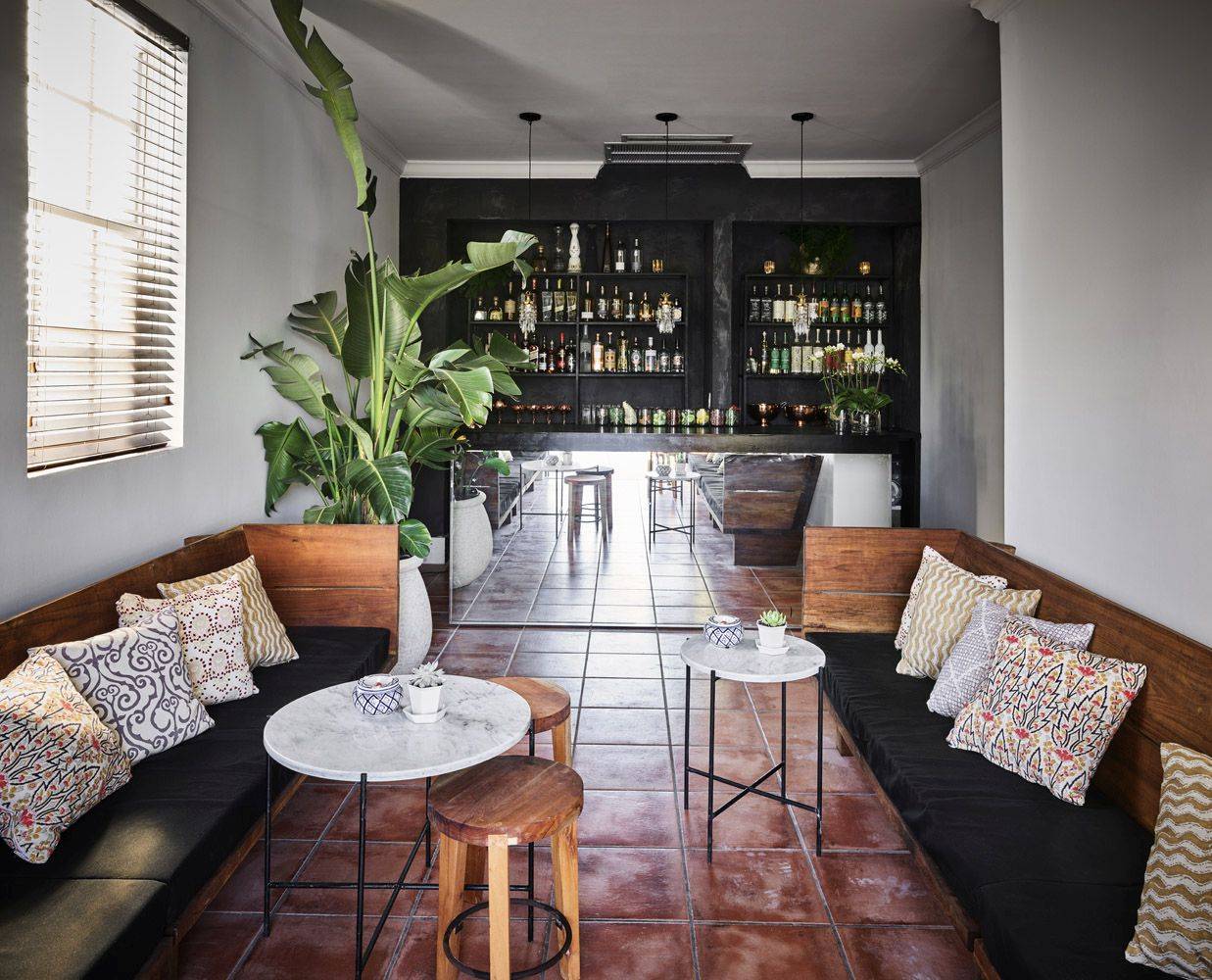 indoor bench seating with bar in the background