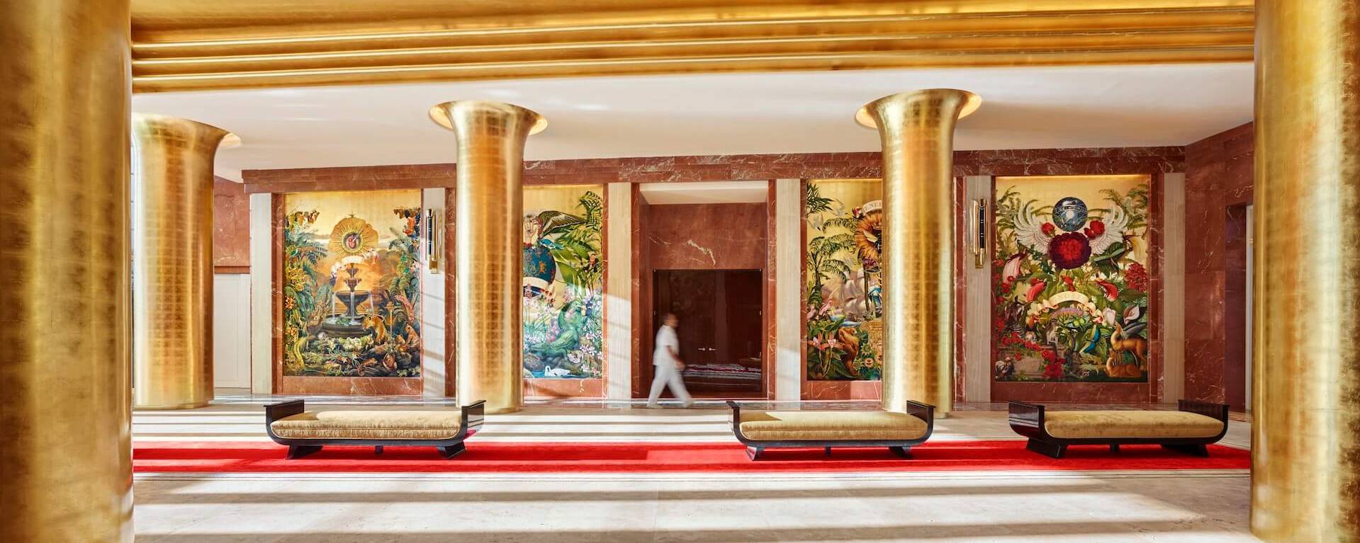 long lobby hallway with golden columns