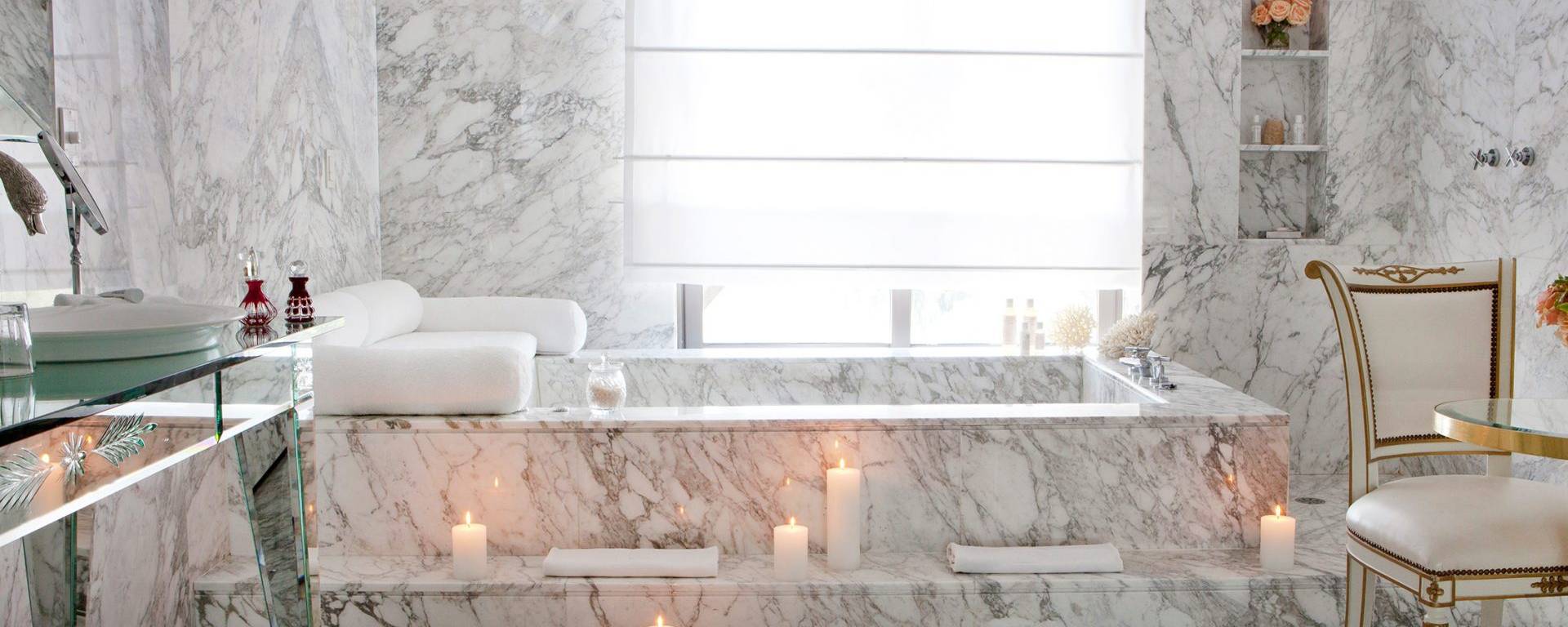 bathtub in hotel room lit by candles
