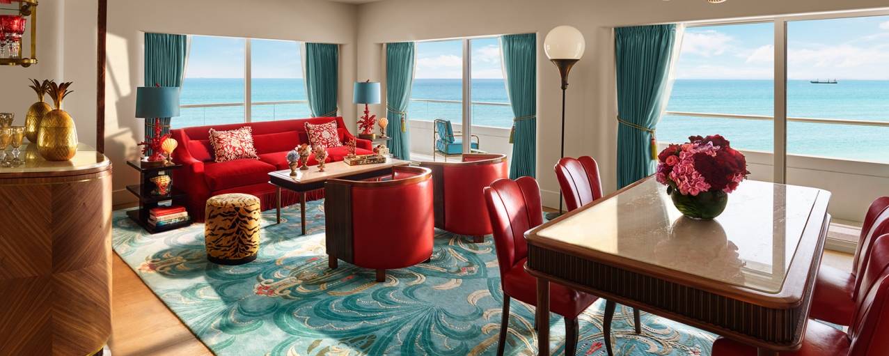 living and dining area with windows overlooking water