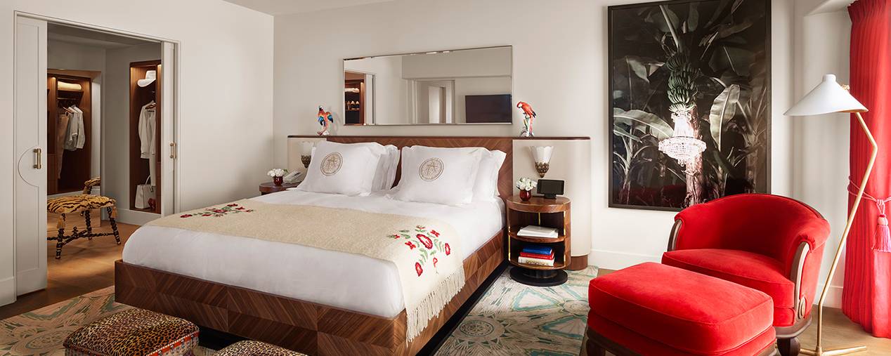bed and chair with entrance to walk in open on the left