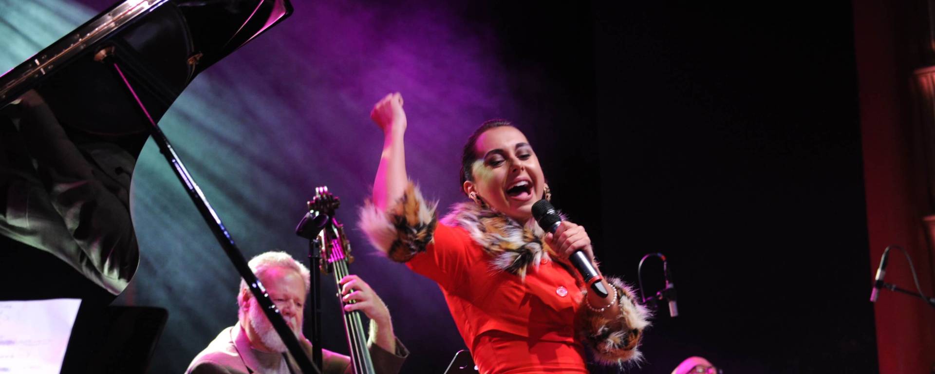 Woman singing on faena theater stage