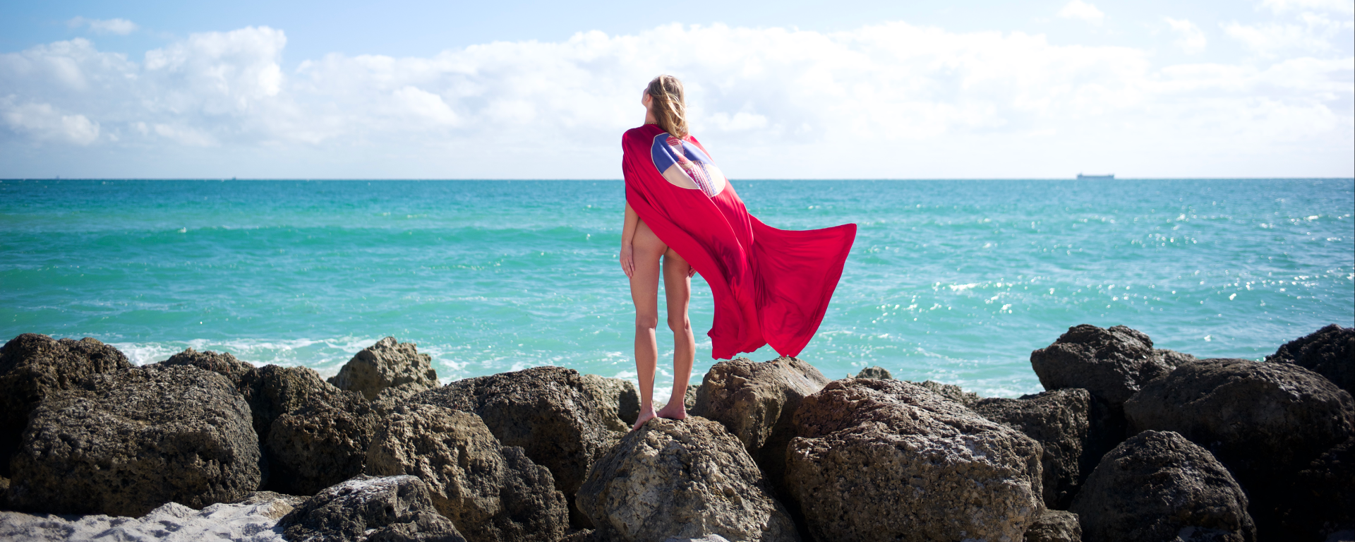 Girl on beach with cape 
