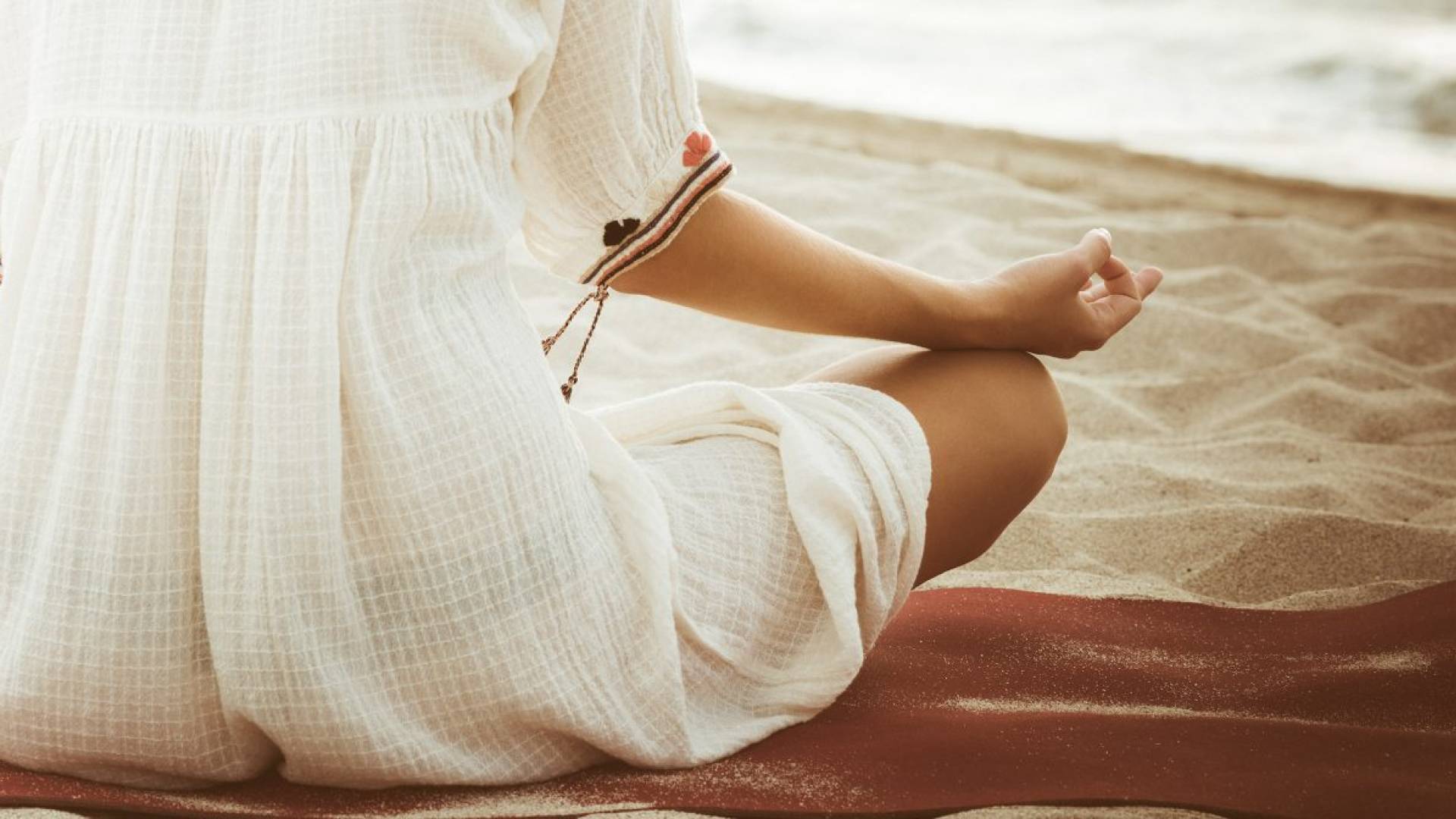 Woman meditating on beach