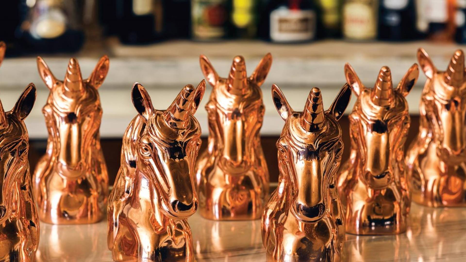 Gold unicorn figurines on table
