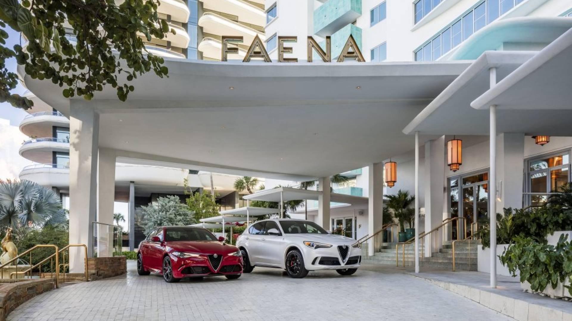 Red and white alfa romeo cars parked in front of Faena hotel