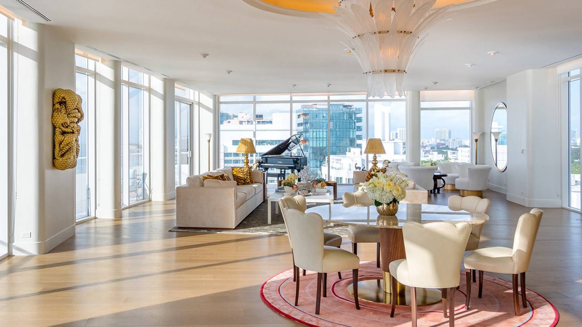 large hotel penthouse with living space and grand piano in the distance
