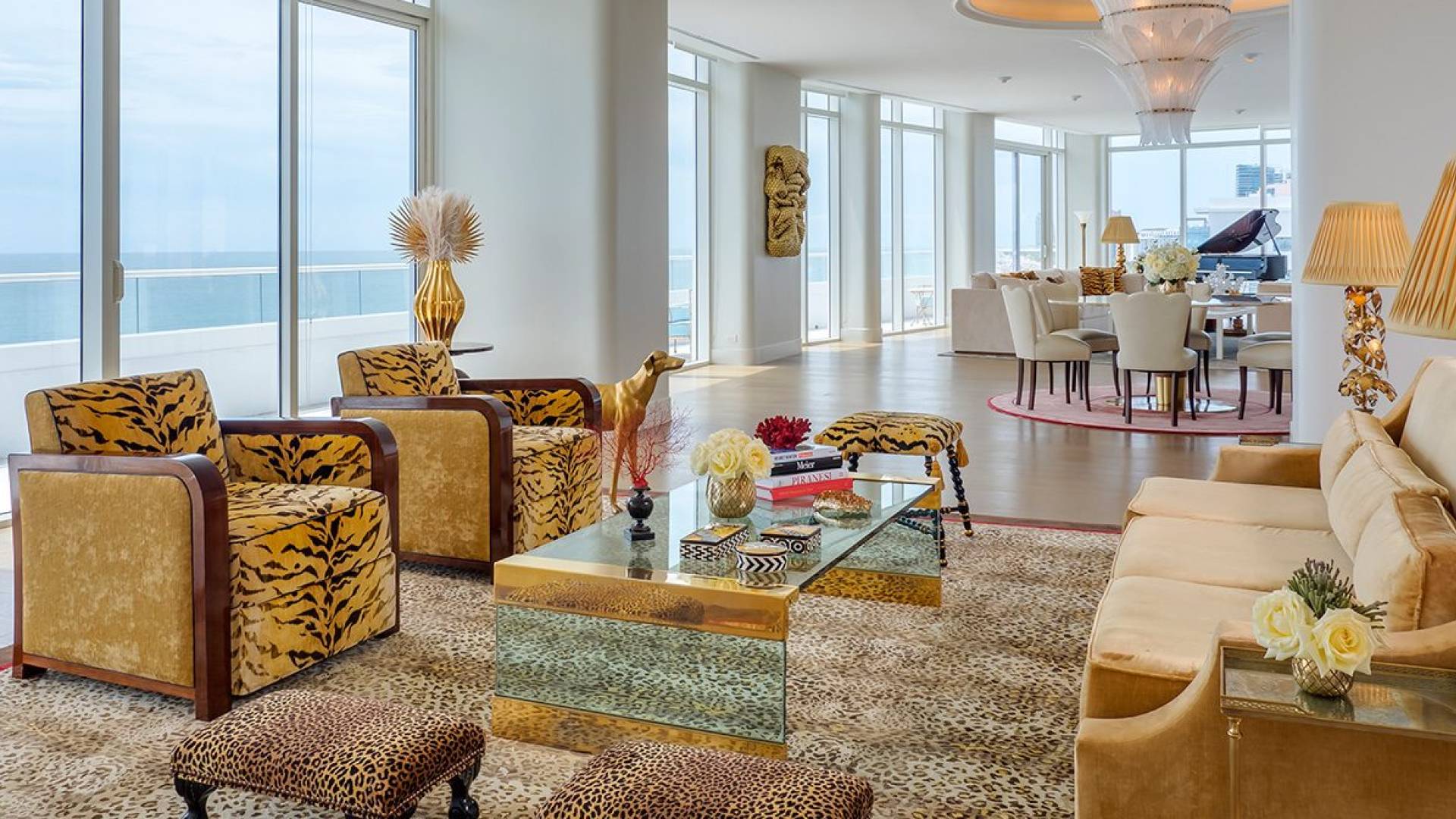 large hotel penthouse with living space and grand piano in the distance