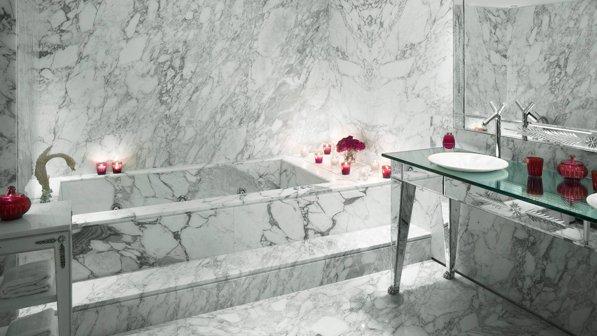 marble bathtub and sink area in hotel suite